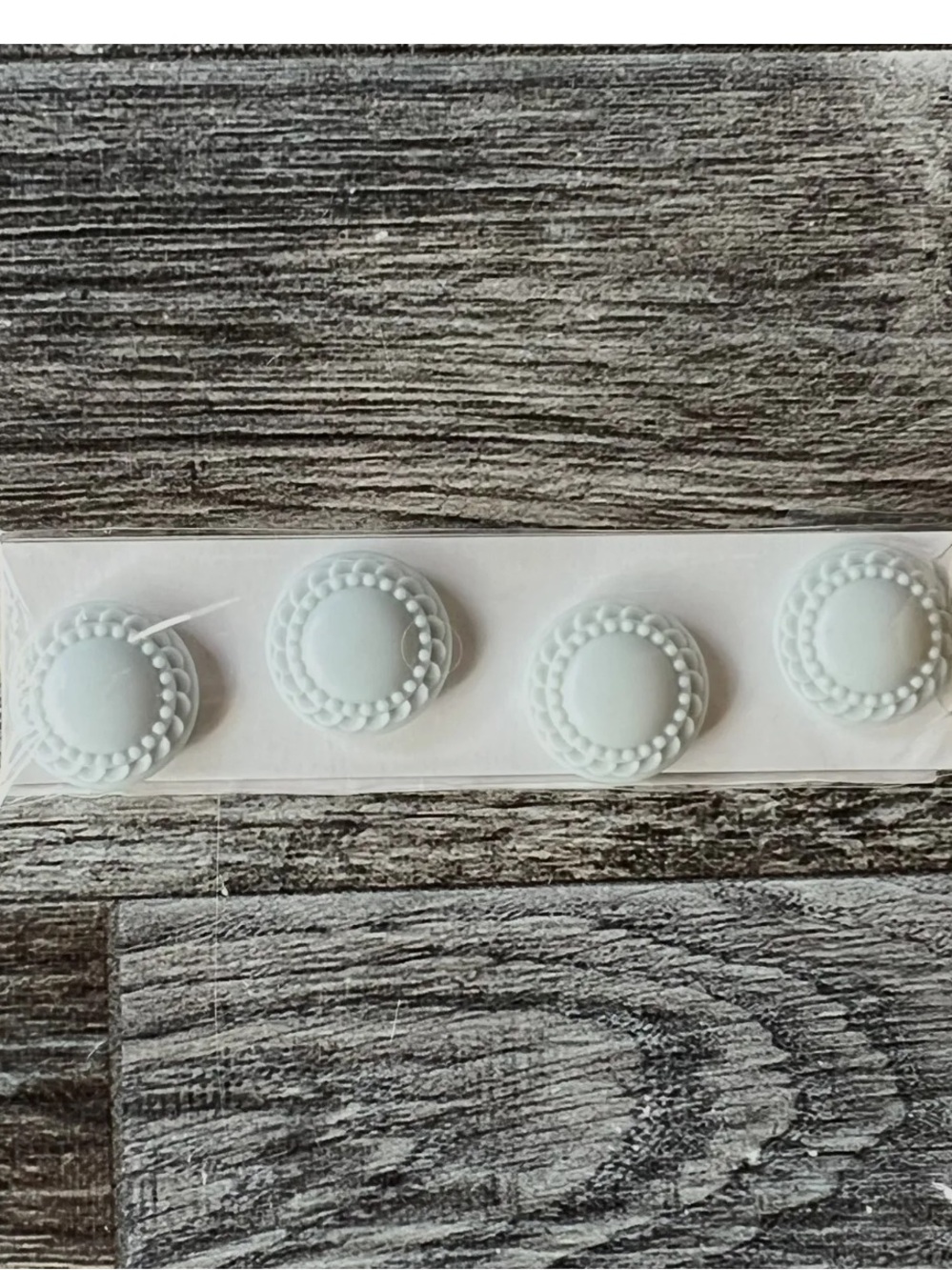 White Round Magnetic small, round, white decorative items that appear to be cab
